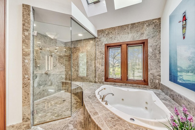 bathroom with a skylight, separate shower and tub, and tile walls