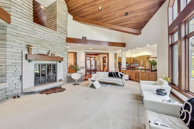 carpeted living room featuring a wealth of natural light, a fireplace, high vaulted ceiling, and wood ceiling