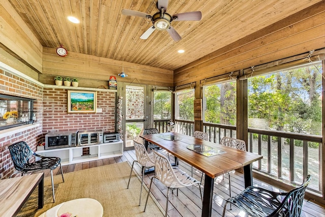 sunroom / solarium with ceiling fan and wooden ceiling