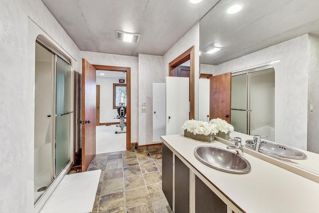 132 N Wynstone Dr, North Barrington, IL 60010 - full bathroom with stone finish flooring, a stall shower, vanity, and baseboards