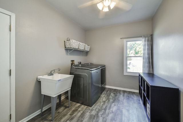 washroom with dark wood-type flooring, washing machine and dryer, and ceiling fan