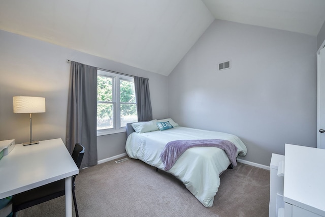 carpeted bedroom featuring lofted ceiling