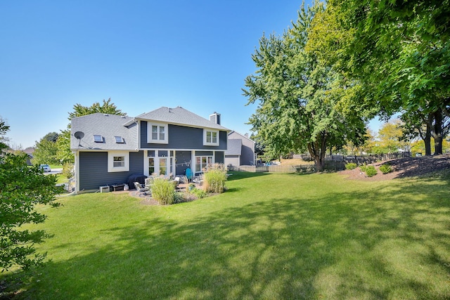 rear view of property featuring a yard and a patio area