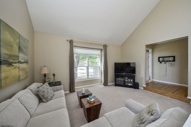 living room with high vaulted ceiling and light wood-type flooring