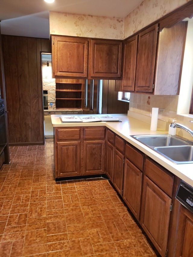 kitchen featuring dishwasher, sink, and kitchen peninsula