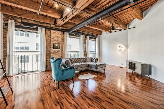 living room featuring hardwood / wood-style flooring, beamed ceiling, and wood ceiling