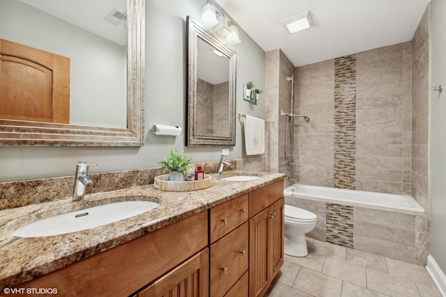 full bathroom featuring tile patterned floors, toilet, vanity, and tiled shower / bath