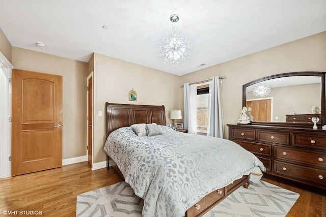 bedroom with a chandelier and hardwood / wood-style flooring