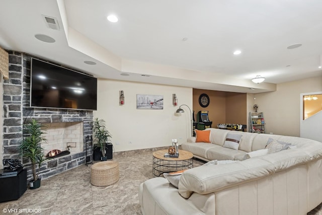 living room featuring a stone fireplace