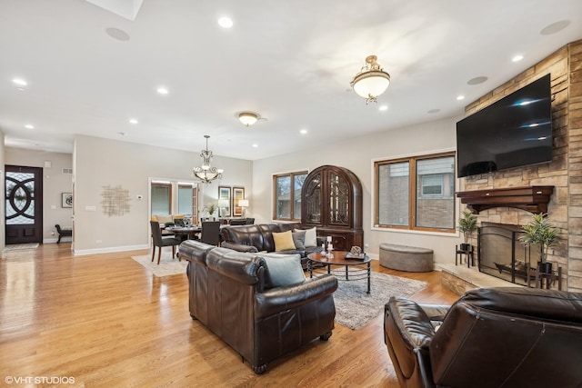 living room with a fireplace, light hardwood / wood-style floors, and plenty of natural light