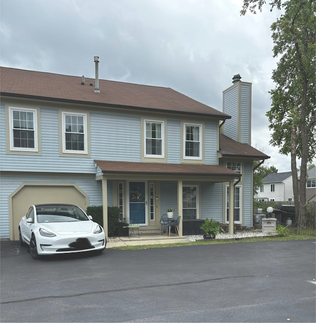 view of front facade featuring covered porch and a garage