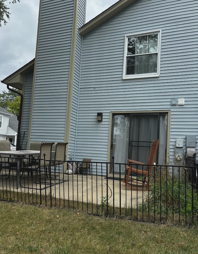 back of house featuring a yard and a patio