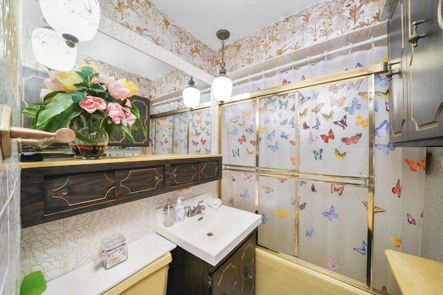 bathroom with vanity and combined bath / shower with glass door