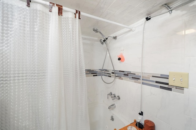 bathroom with shower / bath combo with shower curtain