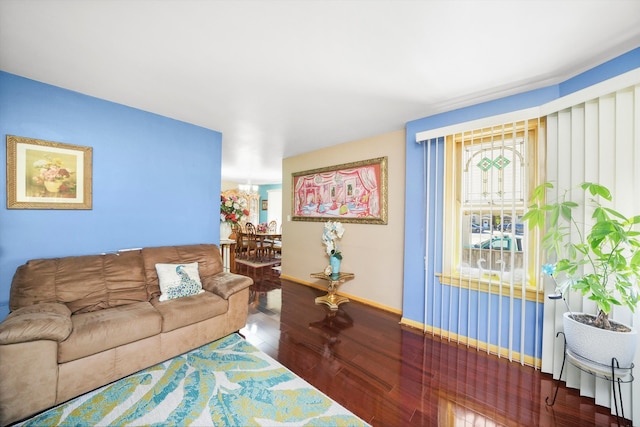 living room featuring a notable chandelier and hardwood / wood-style floors