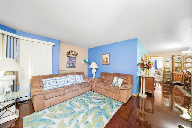 living room with a baseboard heating unit, a chandelier, and dark hardwood / wood-style floors