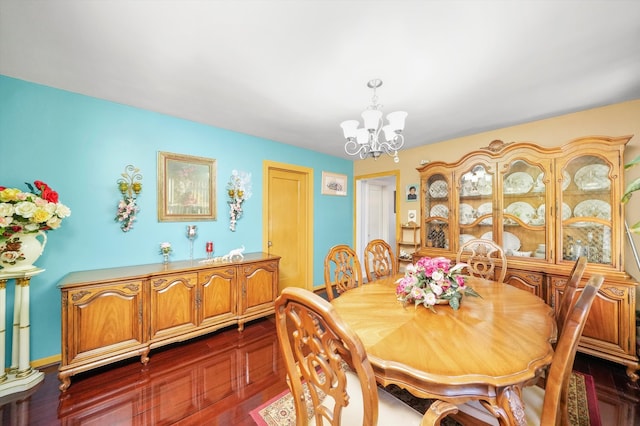 dining room with a notable chandelier and dark hardwood / wood-style floors