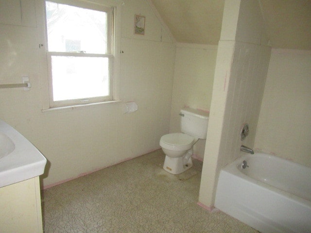 full bathroom with shower / bathtub combination, vaulted ceiling, vanity, and toilet