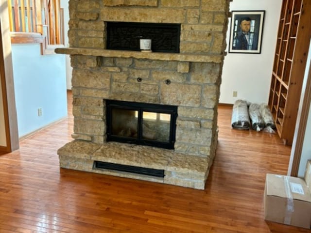 details with a fireplace and hardwood / wood-style flooring