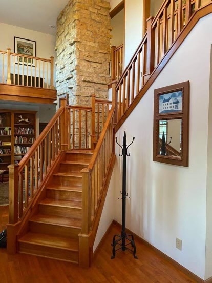 staircase with hardwood / wood-style floors