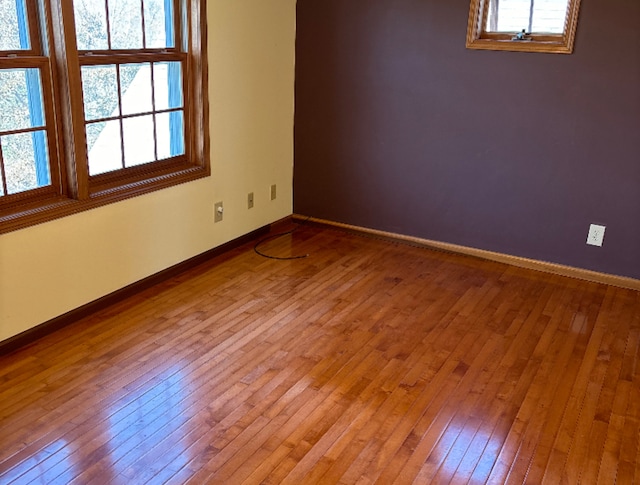 unfurnished room featuring hardwood / wood-style flooring