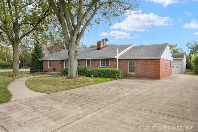 view of front of house with a garage, an outdoor structure, and a front yard