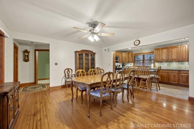 dining room featuring light wood-type flooring and ceiling fan