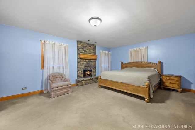 bedroom with carpet floors and a brick fireplace