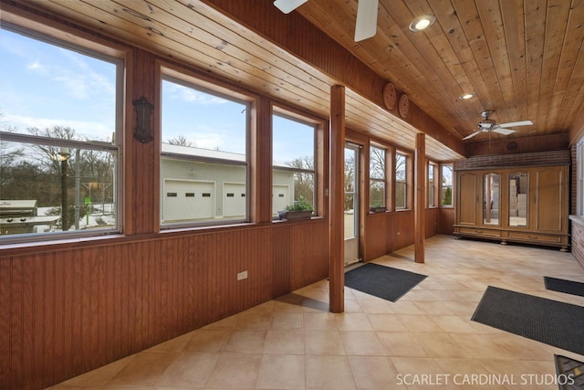 unfurnished sunroom featuring ceiling fan and wooden ceiling