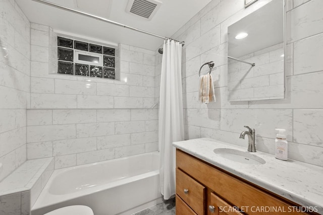 bathroom featuring vanity, shower / bathtub combination with curtain, and tile walls