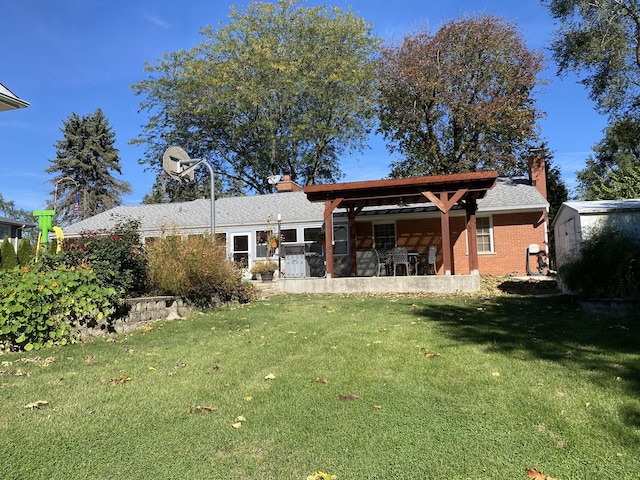 rear view of property featuring a yard and a patio