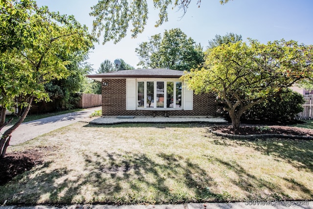 rear view of property with a lawn