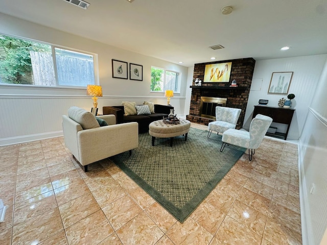 living room with a brick fireplace