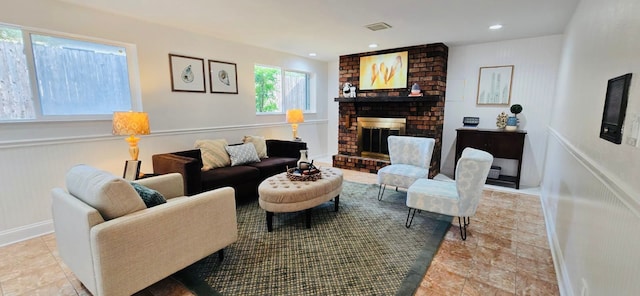 living room with a brick fireplace