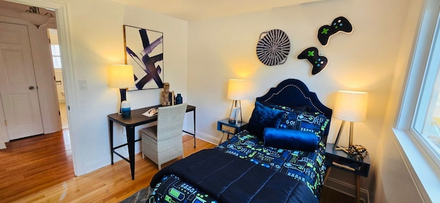 bedroom with hardwood / wood-style flooring