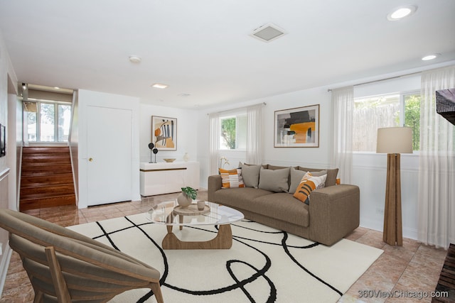 living room with plenty of natural light and light tile patterned floors