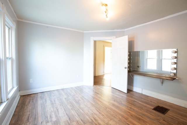 spare room featuring ornamental molding and hardwood / wood-style floors