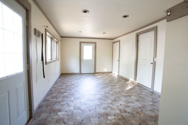 unfurnished room featuring crown molding