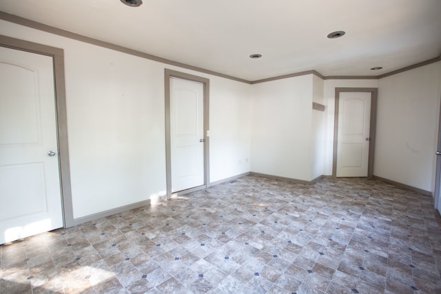 empty room featuring crown molding