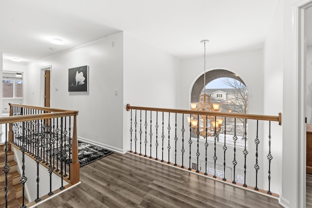 hall featuring dark hardwood / wood-style flooring and an inviting chandelier