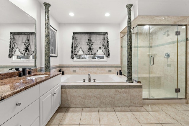 bathroom with plus walk in shower, vanity, and tile patterned floors