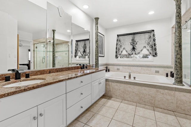 bathroom with shower with separate bathtub, vanity, and tile patterned floors