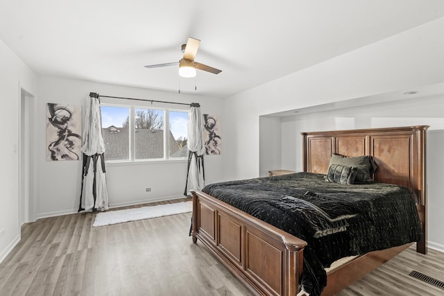 bedroom with ceiling fan and light hardwood / wood-style floors