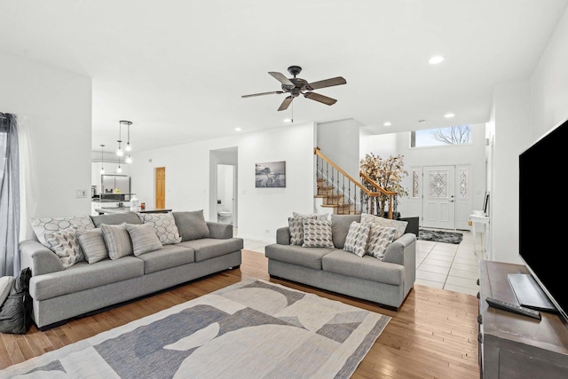 living room featuring ceiling fan and light hardwood / wood-style flooring