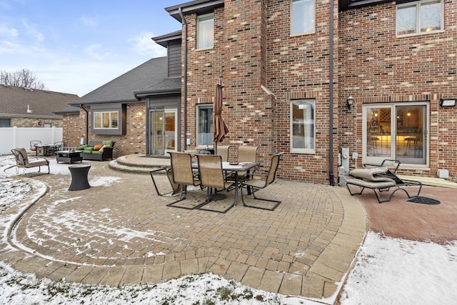 snow covered patio featuring an outdoor hangout area