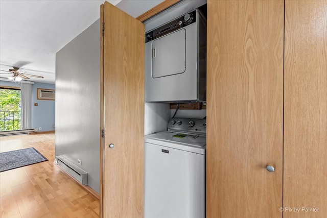 washroom featuring light hardwood / wood-style floors, ceiling fan, stacked washer and dryer, a baseboard radiator, and an AC wall unit