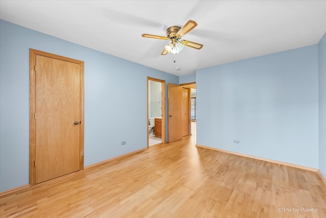 unfurnished bedroom with light wood-type flooring, ceiling fan, ensuite bathroom, and a closet