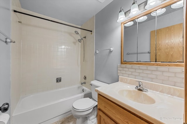 full bathroom featuring decorative backsplash, vanity, tiled shower / bath, tile patterned floors, and toilet