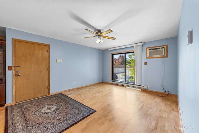 entrance foyer with light hardwood / wood-style floors, a wall mounted air conditioner, baseboard heating, and ceiling fan