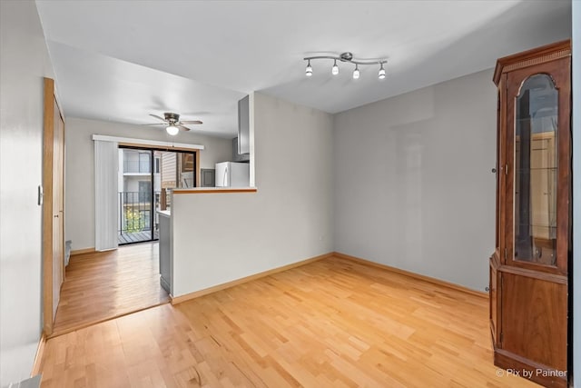 unfurnished room with ceiling fan and light hardwood / wood-style flooring